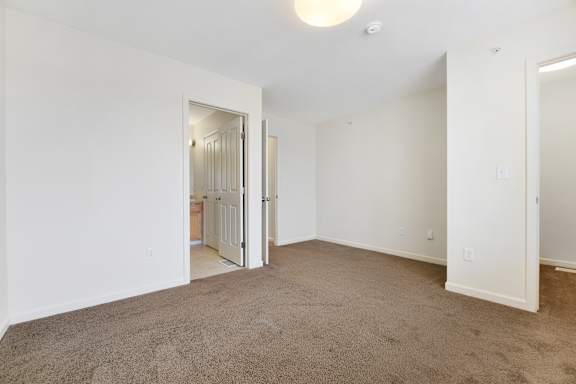 a bedroom with white walls and carpet at Creekwood Apartments, Watertown, 13601