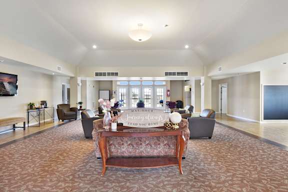 A living room with a couch and a coffee table in the middle at Creekwood Apartments, Watertown, 13601