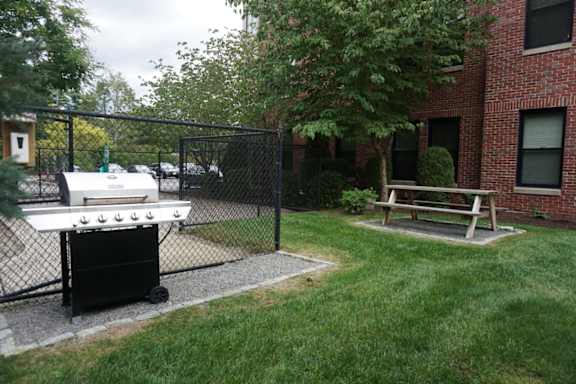 Grilling Station With Benches And Landscaped Grounds Wilber School Apartments