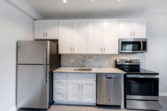 Stainless steel kitchen and white cabinets at Connecticut Plaza Apartments, Washington, District of Columbia