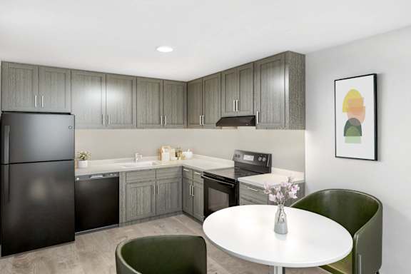 A modern kitchen with a black refrigerator and grey cabinets at 35 Broadway, Menands, NY.