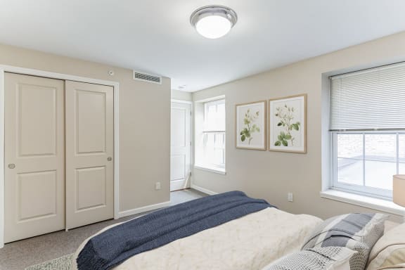 a bedroom with a bed and two windows at 13 State Street Apartments, New York