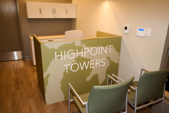 A reception area with a sign that says Highpoint Towers at Highpoint Towers Apartments, Erie, PA