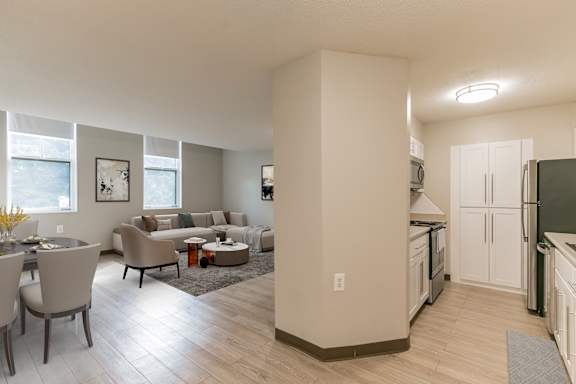 A kitchen and living room with a dining table and chairs at Mill House Apartments, Greenfield, MA, 01301