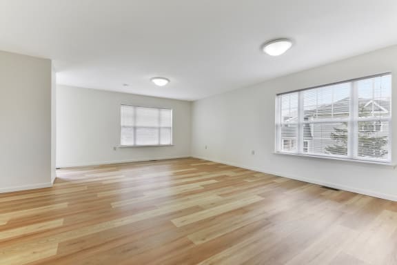 a bedroom with hardwood floors and white walls  at Summit Wood Apartments, Watertown, 13601