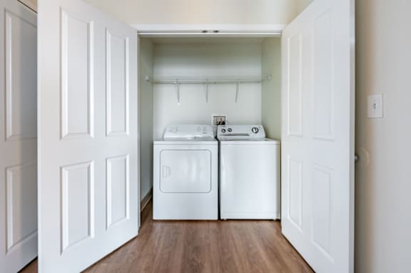 A white laundry room with a washer and dryer.