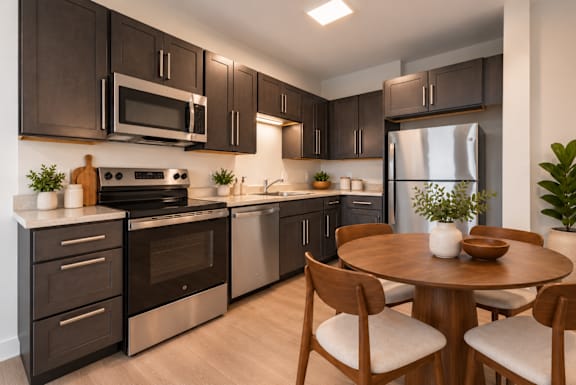 A modern kitchen with dark brown cabinets and stainless steel appliances.