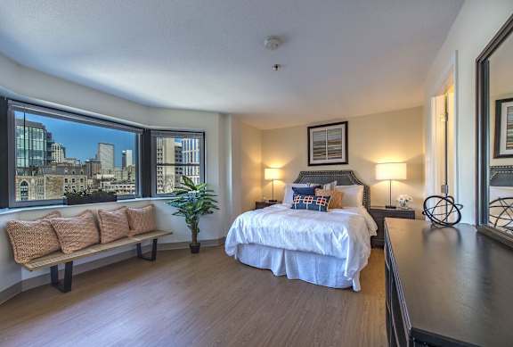 a bedroom with a bed and a large window at Waterford Place, Massachusetts, 02118