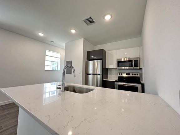 a kitchen with a large counter top and a sink