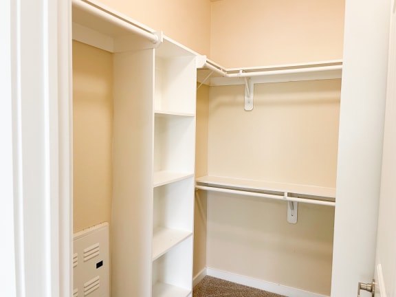 a walk in closet at the oxford at estonia apartments in san antonio,