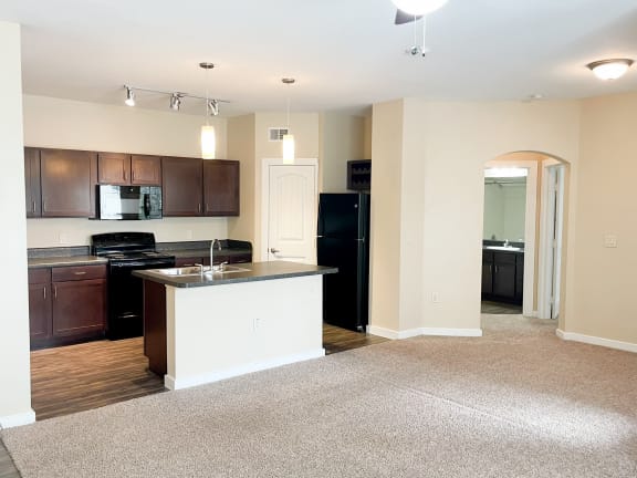 a kitchen and living room in an apartment