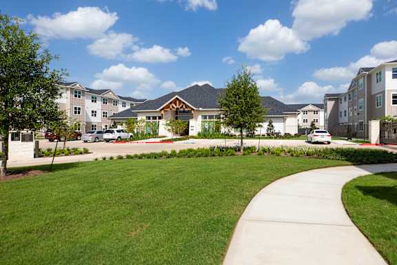 A residential area with houses and a clear sky at 55 Fifty at Northwest Crossing, Houston, TX 77092