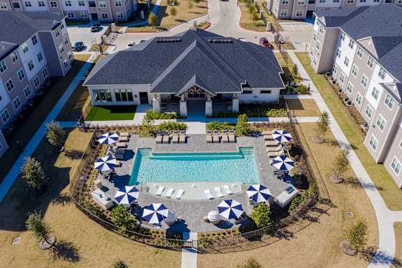 Property overview primarily showing the community building and pool for a birds eye view.