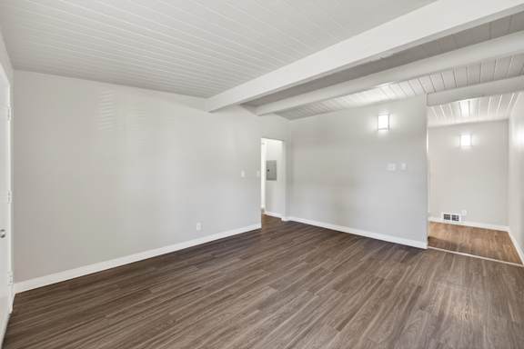 A room with wooden flooring and white walls.