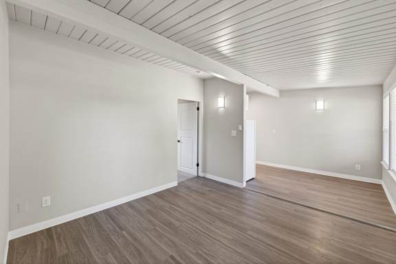 A room with a wooden floor and a white ceiling.