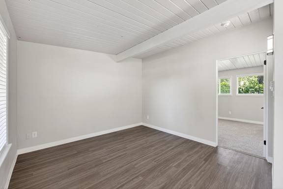 A room with a white ceiling and wooden flooring.
