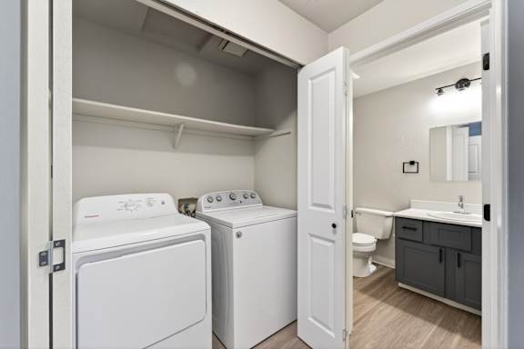 A small laundry room with a washer and dryer.
