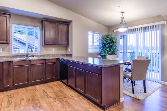 A kitchen with wooden cabinets and a countertop.