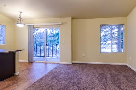 A room with a brown carpet and a black counter.