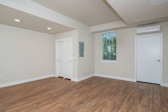 A room with wooden floors and white walls.