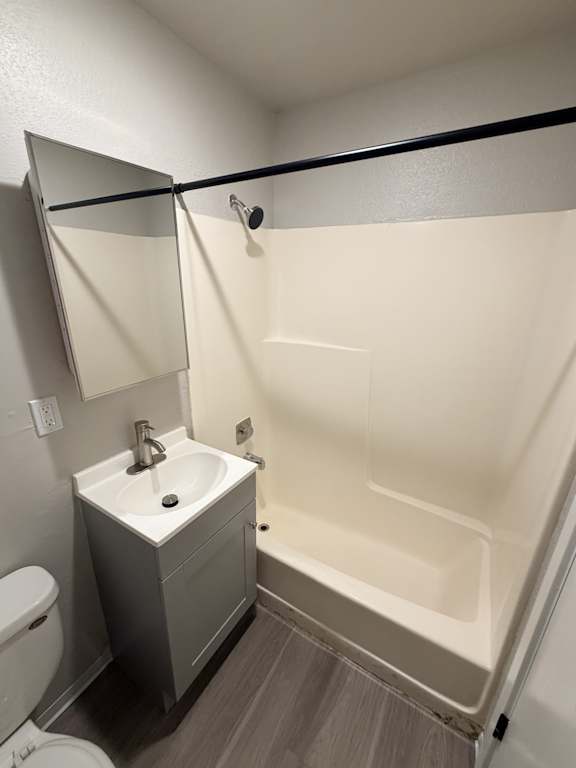 A white sink is on a cabinet in a bathroom.