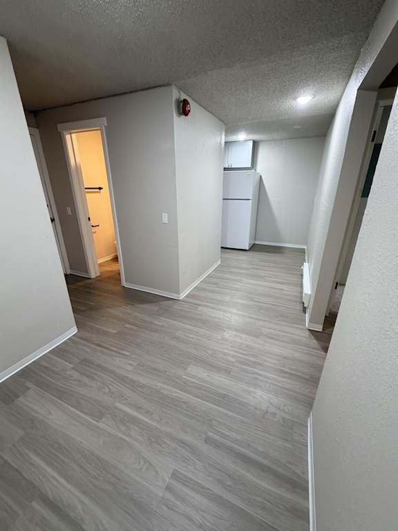 A hallway with a white door and a white cabinet.