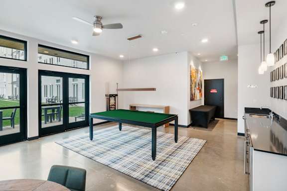 A modern living room with Billiards table at The Hub Apartments, Lacey, WA