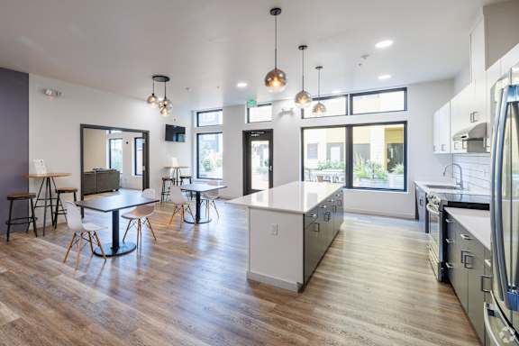A modern kitchen with a dining table and chairs.