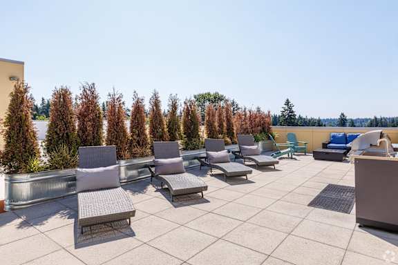 A patio with chairs and a table.