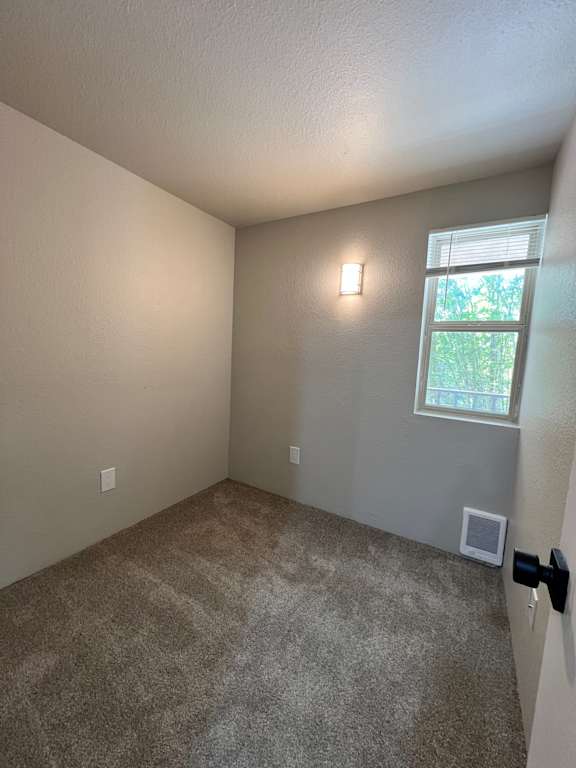 A room with a window and a ceiling fan.