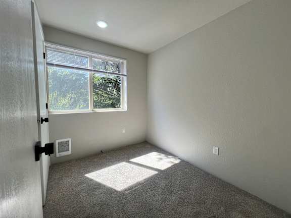 A room with a window and a door.