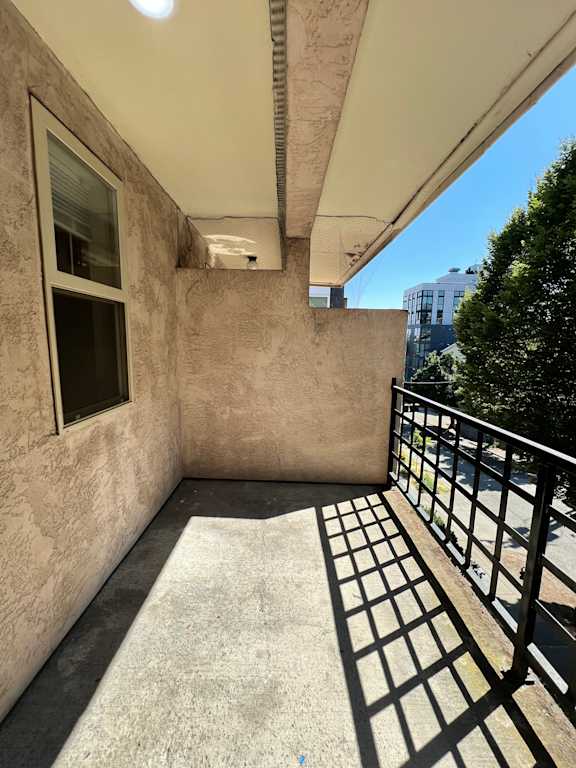 A view of a staircase leading up to a window in a building.