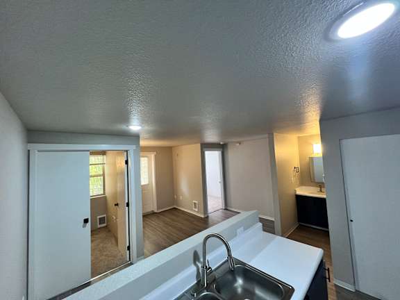 A bathroom with a sink and mirror.