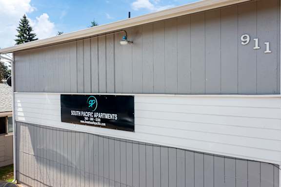 A building with a sign that says South Pacific Apartments.
