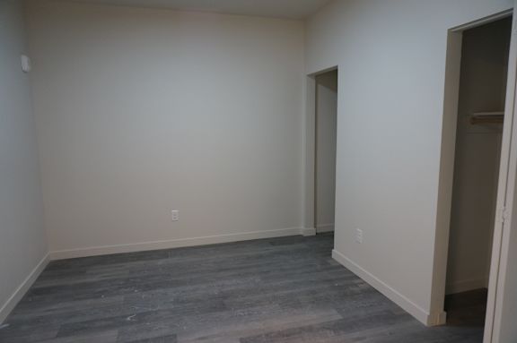 A room with a grey floor and white walls.