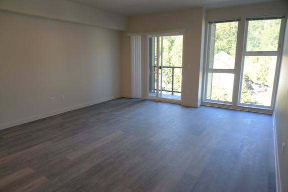 A room with wooden floors and sliding glass doors.