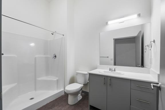 a bathroom with a toilet sink and shower