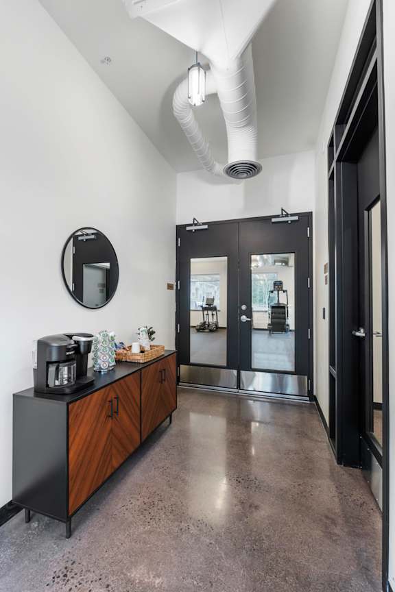 A modern kitchen with a black countertop and a wooden cabinet.