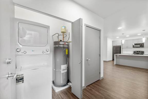 A modern bathroom with a toilet, sink, and a water filter system.