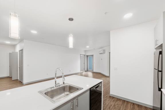 A modern kitchen with a sink and a refrigerator.