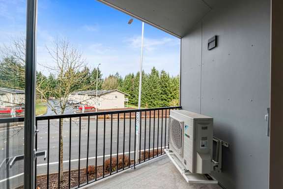 A balcony with a window and a heater unit.