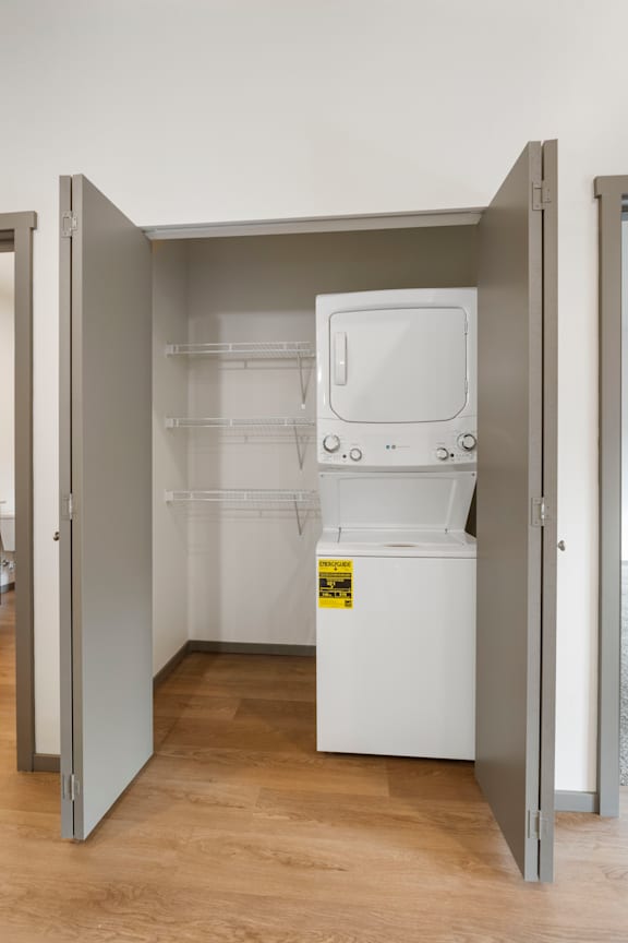 A white dishwasher is in a small kitchen space.