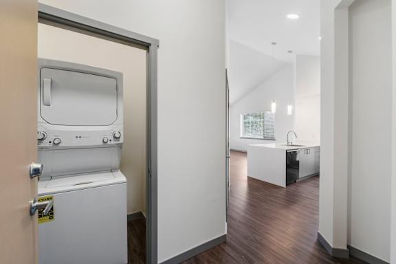 a bedroom with a washer and dryer in a room