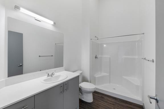 a bathroom with a toilet sink and shower