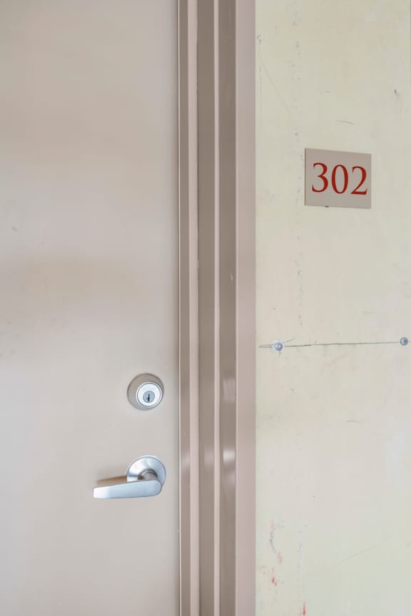 A door with a number 302 on it.