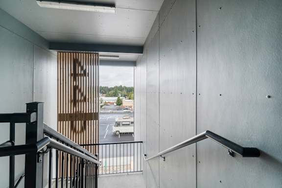 A view from the top of a staircase looking down at a parking lot.