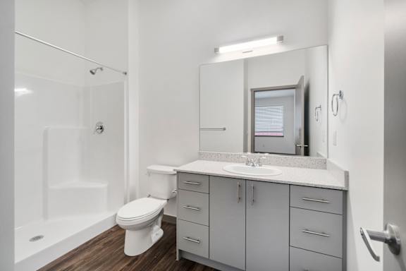 A white bathroom with a toilet, sink, and bathtub.