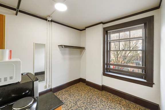 Studio # 1 living space with cooking area, refrigerator, microwave