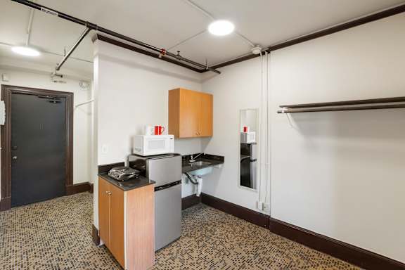 Studio #1 kitchen area with a microwave, oven, and sink.