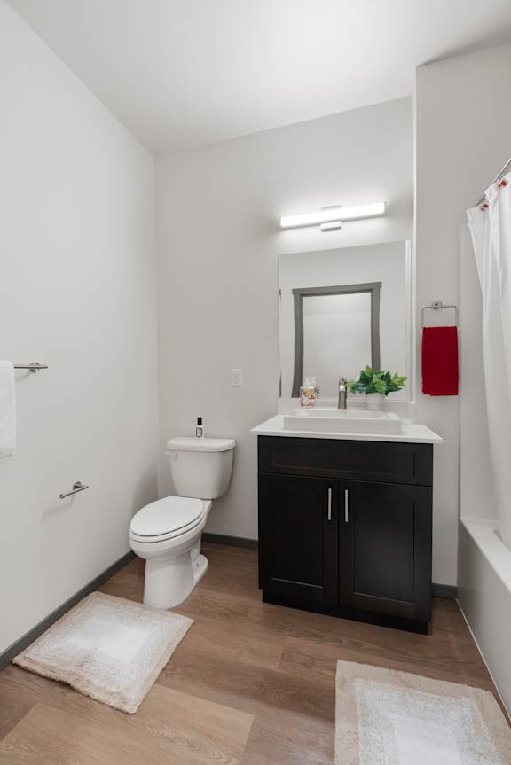 A bathroom with a white toilet and a white sink.